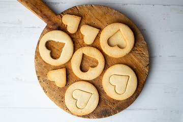 Preparing butter cookies for children with star and heart shapes.