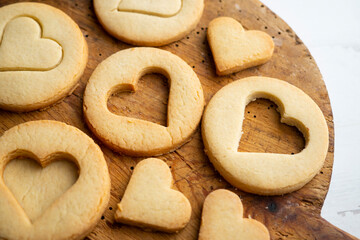 Preparing butter cookies for children with star and heart shapes.