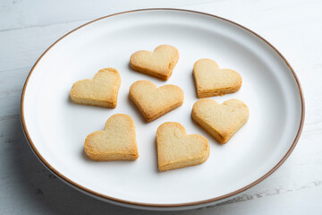 Preparing butter cookies for children with star and heart shapes.