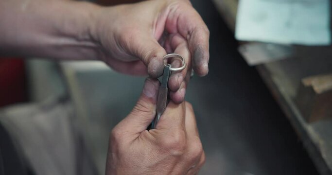 jeweler makes silver wire measurements using caliper in preparation for the production of jewelry or a ring