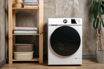 Washing machine in a gray modern laundry room