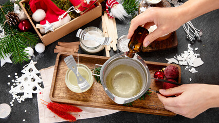 Making decorative aroma candle. Set for homemade Christmas wax candles - obrazy, fototapety, plakaty
