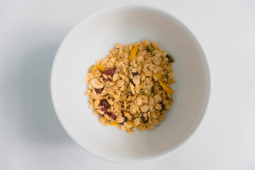 Breakfast granola with fruit in a white bowl Food photography