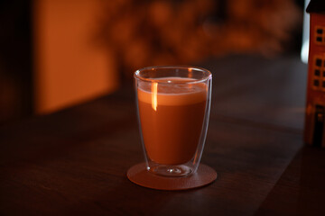 Warm coffee/choco drink on wooden table. Fall and winter mood.