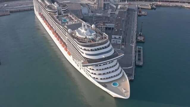 Massive luxury cruise ship docked at port of Genova, Italy. Aerial view