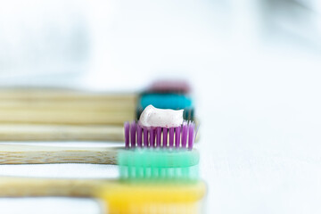 toothpaste on a toothbrush. bamboo material. oral hygiene