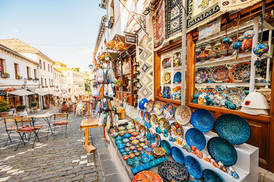 Clock tower in the castle in Gjirokaster, Albania. Souvenir shops in old town of Gjirokaster in Albania.