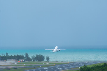 White airplane take off from runway ,airport near sea
