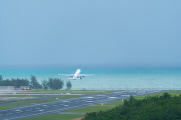 White airplane take off from runway to sky