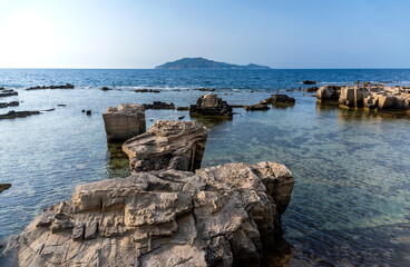 A landscape with a rocky coast in the evening