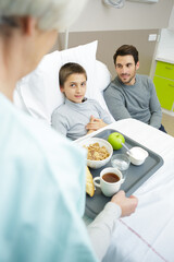 father taking care of son at hospital