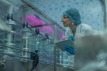 Water production QA specialist monitors and logs conveyor operations for seamless manufacturing flow