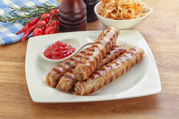 Grilled sausages with cabbage and sauce