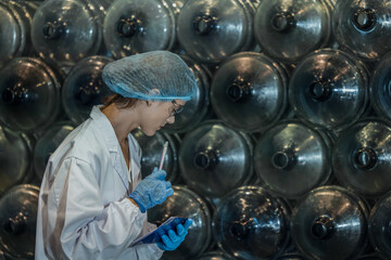 Water production QA specialist monitors and logs conveyor operations for seamless manufacturing flow