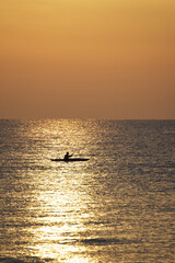 Canoe fisherman at sea at dawn