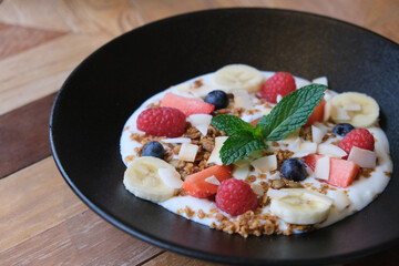 close up plate of fruit yogurt on table. Healthy food