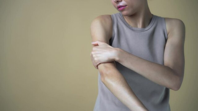 A woman applying cream to her arm. Skin care concept.