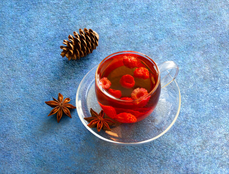 Vitamin tea with raspberries on a blue background