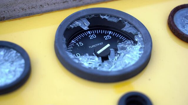 Static close-up shot of broken water gauge on yellow tank