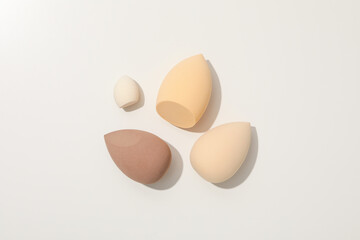 Cosmetic sponges on white background, top view