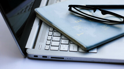 laptop, books and glasses on the table. work space, study area. office concept