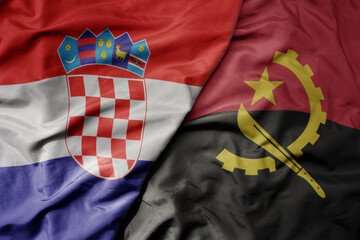 big waving national colorful flag of croatia and national flag of angola .