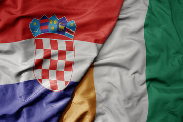 big waving national colorful flag of croatia and national flag of cote divoire .