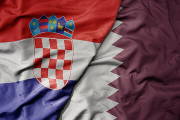 big waving national colorful flag of croatia and national flag of qatar .