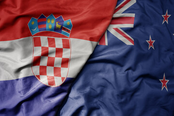 big waving national colorful flag of croatia and national flag of new zealand .