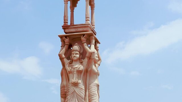 artistic red stone jain god holy pillar at morning from unique angle video is taken at Shri Digamber Jain Gyanoday Tirth Kshetra, Nareli, Ajmer, Rajasthan, India.