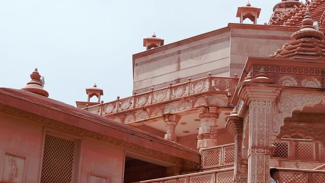 artistic hand carved red stone jain temple at morning from unique angle video is taken at Shri Digamber Jain Gyanoday Tirth Kshetra, Nareli Jain Mandir, Ajmer, Rajasthan, India.