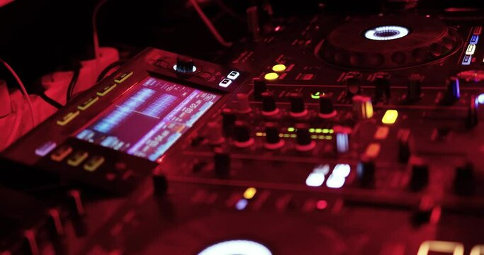 Nightclub, nightlife concept. DJ hands mixing DJ remote.