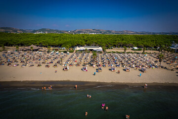 Aerial drone view of Spille beach in Albania with pine forest