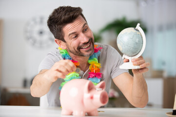 man holding moneybox and globe