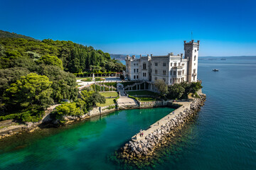 An aerial of the Miramare Castle in the scenic Gulf of Trieste in Italy captured on a bright day