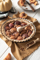 Autumn baking in the form of a pie with peaches on the table