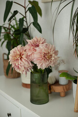 A bouquet of pink dahlias in a home interior