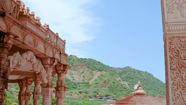 artistic hand carved red stone jain temple at morning from unique angle video is taken at Shri Digamber Jain Gyanoday Tirth Kshetra, Nareli Jain Mandir, Ajmer, Rajasthan, India.