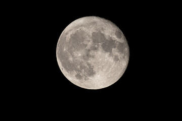 Full moon photographed with a telescope and reflex camera where the craters on the lunar surface can be seen. The seventh continent will be the destination for space travel and future moon landings