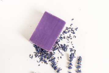 lavender handmade soap isolated on light background, on bed sheet with flowers and purple sack for...