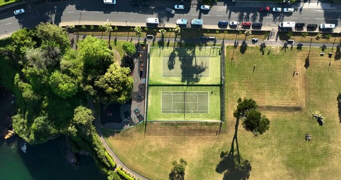 Aerial view over a tennis court and street in Dunmore East, Ireland 4k
