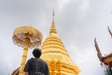 asian man travel and see to gold temple at chiangmai  Thailand in summer season