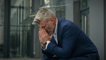 Pensive Caucasian middle-aged old man feeling headache eyes strain discomfort thinking thoughtful unwell senior businessman worried problem migraine worry failure mature business male in city outdoors - obrazy, fototapety, plakaty