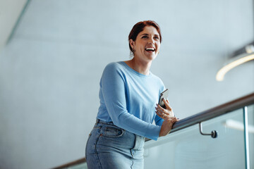 Successful business woman and entrepreneur smiling with joy in an office