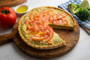 French style quiche with broccoli, salmon, and slices tomato.