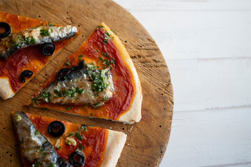 Neapolitan pizza with tomato and sardines.