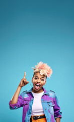 Fototapeta premium Young African American woman with colourful dyed hair, cheeky attitude, smiling and pointing finger up to empty copy space. Vertical banner. Generative AI