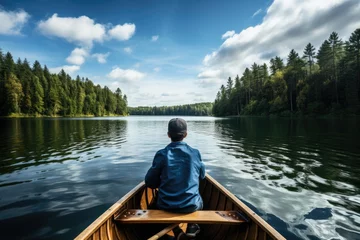 Foto op Canvas boy in a boat on peaceful lake outdoor adventure © krissikunterbunt