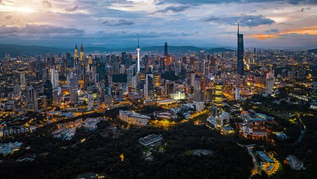 Kuala Lumpur city skyline with dramatic sky , twilight scene . Malaysia .
