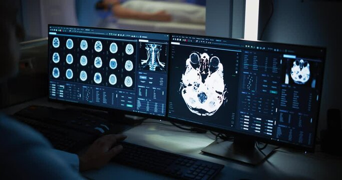 In Medical Laboratory Patient Undergoes MRI or CT Scan Process, in Control Room Doctor Watches Procedure and Monitors with Brain Scans Results. Healthcare Facility with High-Tech Equipment